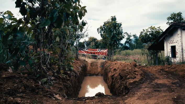 Off-road mud obstacle course prepared for a 4x4 adventure event, featuring a deep water trench surrounded by trees and rugged terrain in a rural outdoor setting. Off-road mud obstacle course prepared for a 4x4 adventure event, featuring a deep water trench surrounded by trees and rugged terrain in a rural outdoor setting.